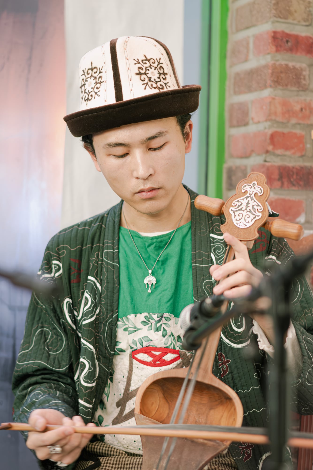 Komuz player in kalpak